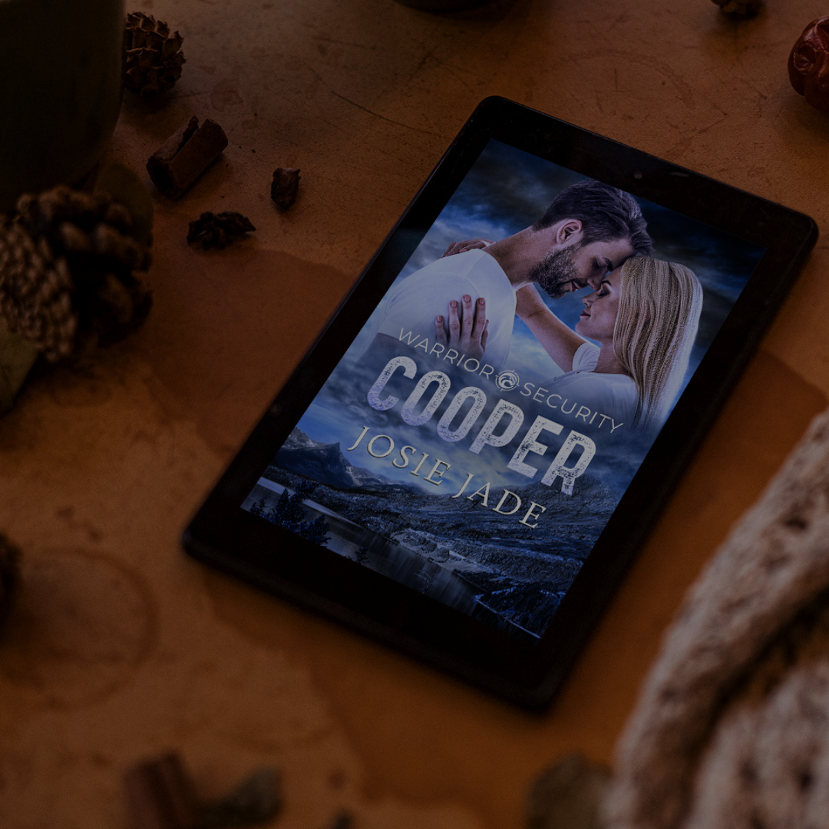 Warrior Security: Cooper on an e-reader against a backdrop of pinecones